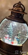 img 1 attached to Christmas Magic In A Lantern: Musical And Lighted Snow Globe For Home Decor And Gifting review by Chad Delgado
