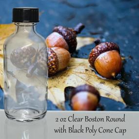 img 1 attached to 24-Pack Of 2 Oz. Clear Boston Round Glass Bottles With Black Cone Caps From GBO GlassBottleOutlet.Com