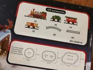 img 1 attached to Experience The Magic Of The Holidays With PUSITI Classic Christmas Train Set - Battery Operated Locomotive Engine And 11.5 Ft Tracks With Lights And Sounds For Kids' Delight review by Sergio Guardado