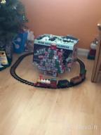 img 1 attached to Experience The Magic Of The Holidays With PUSITI Classic Christmas Train Set - Battery Operated Locomotive Engine And 11.5 Ft Tracks With Lights And Sounds For Kids' Delight review by Tim Thornton