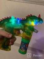img 1 attached to Toysery Dinosaur Bubble Gun - Colorful Bubble Blower Toy For Kids With LED Lights, Music Chimes, And Complimentary Batteries (2 Pack) review by Matt Davis