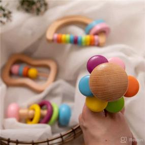 img 2 attached to Organic Colorful Baby Rattle Set - Safe Food Grade Wood Rattlers, Soother Bracelets, and Teethers for Montessori Toddler Toy - Multicolored (4pc)