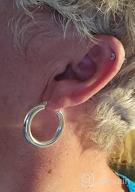 img 1 attached to Stylish Chunky Hoop Earrings for Women - Shiny Polished Round-Tube Hoops with Sterling Silver Posts: Perfect Gift for Women and Girls review by Greg Floyd