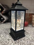 img 1 attached to Christmas Magic In A Lantern: Musical And Lighted Snow Globe For Home Decor And Gifting review by Michael Nastanovich
