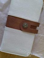 картинка 1 прикреплена к отзыву Большой кожаный женский кошелек с органайзером, визитницей и браслетом - Дизайнерский дорожный клатч черного цвета с коричневыми вставками от CLUCI от Michael Luna