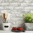 peel and stick wallpaper in gray and taupe brick design by roommates (rmk11805wp) logo