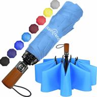 compact windproof travel umbrella with light blue inverted design, perfect for backpacking: durable wooden handle, inside-out functionality and backpack rain protection. logo