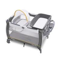 👶 graco pack 'n play care suite bassinet playard, wells: a versatile and convenient baby product logo