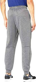 img 1 attached to Nike Therma Men's Dri-FIT Tapered Training Pants 👖 in Grey Heather (CV7739-063) - Advanced Performance and Comfort