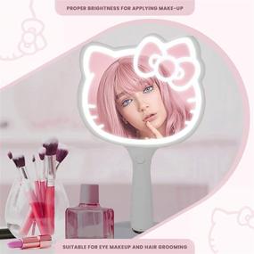 img 2 attached to 💡 Optimize Your Search: Hello Kitty LED Handheld Mirror with Adjustable Brightness & Standing Base for Makeup Vanity