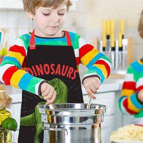 img 1 attached to 👩 Kids Apron Aprons for Kids: Perfect Christmas Gift for Girls and Boys for Cooking, Baking, Painting, Gardening and School Activities - Adjustable Neck Strap, Pockets Included (Black+Dinosaur, 6-12 Years)