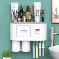🦷 wall mounted toothbrush holder with auto toothpaste dispenser - magnetic toothbrush holder for bathroom and vanity, 4 brush slots, 2 cups, 1 cosmetic drawer, 1 large storage tray by showgoca logo