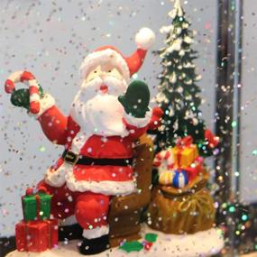 img 1 attached to 🎅 Рождественский музыкальный снежный шар DRomance с таймером, освещенный снежный шар Санта-вертолет, вода, кружащаяся с блестками, рождественская украшение (10.6 x 4.3 x 8.3 дюйма)