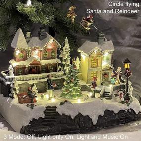 img 2 attached to 🏠 Polyresin Christmas House Collectible Figurine with USB and Battery Dual Power Source - Reindeer Flying Over Town (Model: XH93418) - Enhanced SEO-friendly Product Title