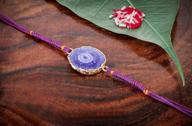 stunning purple designer rakhi bracelet for brother - traditional agate stone, plastic-free packaging on rakshabandhan logo