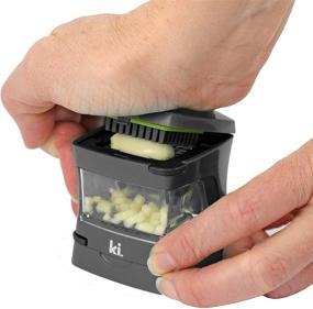 img 2 attached to 🧄 Kitchen Innovations Garlic-A-Peel Garlic Press, Crusher, Cutter, Mincer, and Storage Container - Includes Silicone Garlic Peeler - Effortless Cleaning - Stainless Steel Blades (Grey)