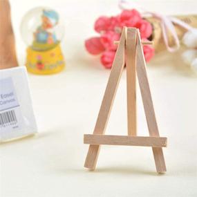 img 2 attached to 🖼️ WOWOSS 12 Pack 5&#34; Mini Wooden Easel Stand, Natural Tripod Holder for Small Canvas Displays, Business Cards, and Photos