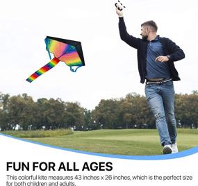 img 2 attached to Premium Animato Large Rainbow Kite for Kids and Adults - Easy to Fly, Fun Outdoor Activity Toy - Rainbow Delta Design - 5 PC Kit with Extra Long String, Storage Bag, and Gloves