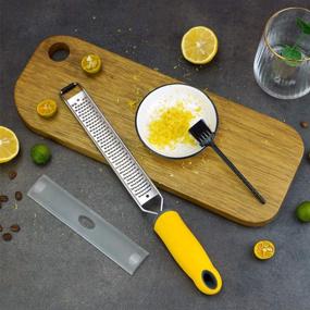 img 2 attached to 🍋 Stainless Steel Zester Grater with Handle - Lemon and Cheese Grater Slicer for Citrus, Garlic, and Chocolate. Includes Protective Cover and Brush