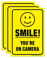 📹 set of 3 smile you're on camera video surveillance signs - 10 x 7 inches | durable .040 rust-free aluminum | ideal for indoor/outdoor use in homes & businesses | cctv security camera warning | uv protected & reflective logo