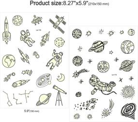 img 1 attached to 🚀 Набор временных татуировок "Сияющая в темноте космическая татуировка": 150 штук, светящиеся солнечная система, вселенная внешнего космоса для детей - идеальное заполнение чулок и праздничное угощение на день рождения!