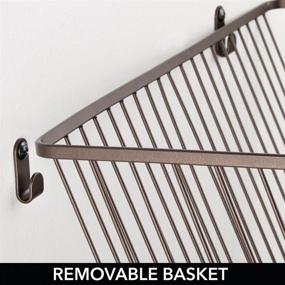 img 1 attached to mDesign Small Portable Metal Farmhouse Wall Decor Angled Storage Organizer Basket Bin with Wall Mount Hooks - Ideal for Entryway, Mudroom, Bedroom, Bathroom, Laundry Room - 2 Pack in Bronze