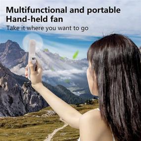 img 2 attached to RIIEYOCA Handheld Small Fan with Phone Holder - Portable Foldable Mini Fan, USB Rechargeable Pocket Fan with 2000mAh Battery, Long Lasting Performance Up to 21 Hours, Ideal for Shopping, Travel, Outdoor Activities, Camping (White)