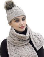 🧣 stay cozy in style: aran crafts women's irish cable knitted soft pom faux fur hat – 100% merino wool logo