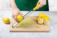 🍋 versatile professional lemon zester & cheese grater: sharp stainless steel blades, handle for parmesan, citrus, lime, ginger, garlic, fruits - dishwasher safe logo