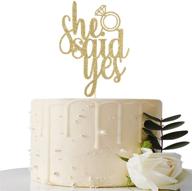 sparkling gold 'she said yes' cake topper for engagement and wedding celebrations логотип