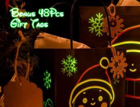 img 1 attached to Набор подарочных пакетов KD KIDPAR Glow in Dark на Рождество - 24 пакета в 4 разных дизайнах (8 больших, 8 средних, 8 маленьких) с 24 бумажными салфетками и 48 ярлыками для подарков - идеально для Рождественской вечеринки.
