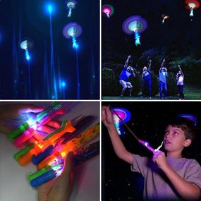 img 1 attached to 🚀 Ainswei JX Rocket Slingshot: 24 Pcs Flying Copters With LED Lights, 12 Pcs Arrow Helicopters, and 12 Pcs Launchers - Perfect for Outdoor Summer Parties and Children's Day Gift - JX Amazing Arrow Helicopter Glow Toys