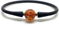 radiant cognac round baltic amber bracelet with black rubber band - natural sparkling bead logo
