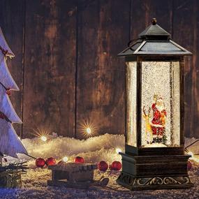img 1 attached to 🎅 Christmas Musical Snow Globes: Lighted Swirling Glitter Lantern with 6H Timer - Battery Operated Hanging Lantern Santa Claus Decorations for Gift and Home Decor