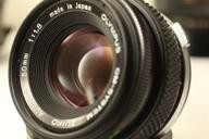om series zuiko camera lens: olympus 📷 50mm f/1.8 - manual focus with autofocus capability logo