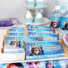 img 1 attached to 🎉 Набор декораций для вечеринки Frozen 2 - 128 шт.: Полный набор для дня рождения на тему Frozen 2 для 10 детей, включая праздничное баннер, скатерть, тарелки, столовые приборы, топперы для торта и кексов, шоколадные наклейки, наклейки на бутылки, фольгированные воздушные шары.