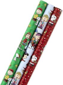 img 4 attached to Hallmark Christmas Peanuts Wrapping Paper Pack - Snoopy, Charlie Brown, Woodstock, 3 rolls (105 sq. ft. total) - With Reverse Cut Lines