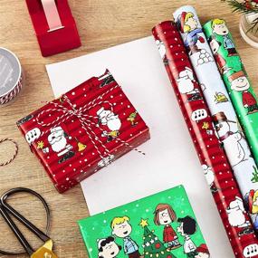 img 3 attached to Hallmark Christmas Peanuts Wrapping Paper Pack - Snoopy, Charlie Brown, Woodstock, 3 rolls (105 sq. ft. total) - With Reverse Cut Lines