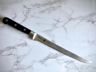 img 1 attached to Ergonomic Santoku Knife 7In KITAKAMI X50CrMoV15 Steel - Non-Slip Handle Multipurpose Stainless Steel FISSMAN Series review by Seth Heck