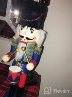 img 1 attached to Handmade Wooden Nutcracker With Flannel Ful Golden Coat - Festive Collectible For Christmas Decorations And Winter Tabletop Displays, FUNPENY 19" Santa Design review by Cody Mckechnie