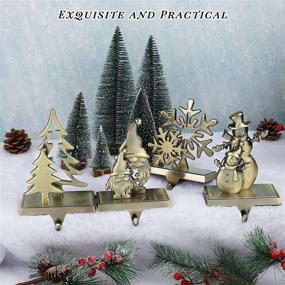img 1 attached to Add Festive Charm To Your Christmas Decor With MCEAST 4-Pc Stocking Holder Set - Bronze Metal Hooks Featuring Snowman, Christmas Tree, Snowflake & Swedish Gnome Design