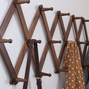 img 1 attached to Expandable Wooden Coat Rack And Accordion Hanger With 20 Pegs, Modern Wall Mount For Hats And Jackets, Walnut Finish By SKOLOO