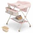 portable folding baby changing table with adjustable height, safety belt, drying & storage rack, mobile nursery organizer stand on wheels for newborn infants - pink logo